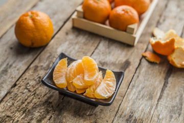 Ripe mandarine citrus . tangerine mandarine orange on wooden background. Mandarins in plate