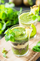 Healthy layered smoothie with kiwi, pineapple, chia seeds