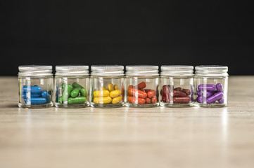 Prescription pills of various colors lined up