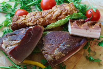 Salted traditional way of pieces of pork, along with chili and vegetables.