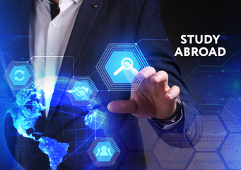 The concept of business, technology, the Internet and the network. A young entrepreneur working on a virtual screen of the future and sees the inscription: Study abroad