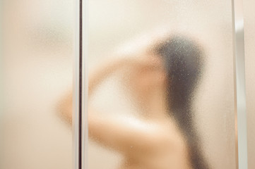 Sensual portrait of young woman taking a shower. Body and skin hygiene