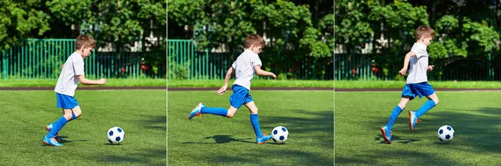 Fotobehang Boy football player running with ball on green lawn © Sergey Ryzhov
