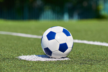 Soccer ball on grass of football stadium