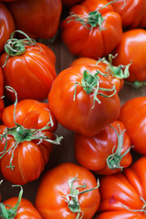 A box of red tomatoes sold on the market.