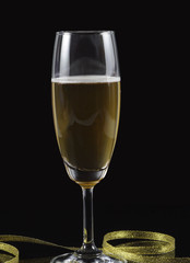 Champagne isolated black background, gold ribbon