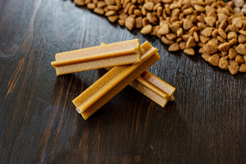 Dry pet food on black wooden table.