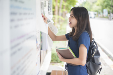 A female university student is exciting with the exam report