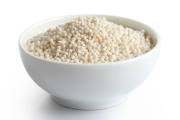 Dry tapioca pearls in white ceramic dish isolated on white. 