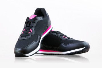 Black sneakers. Closeup of a pair of black unbranded sneakers on white background.