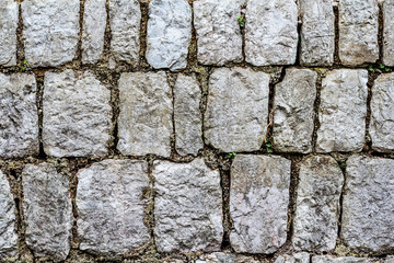 Background of gray stones. A fragment of an old wall or a fence.