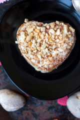 Heart dessert on black ceramic plate, beautiful and delicious.
