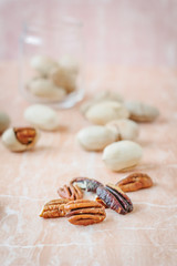 Fototapeta na wymiar Nice pecan nuts over pink plastic board.