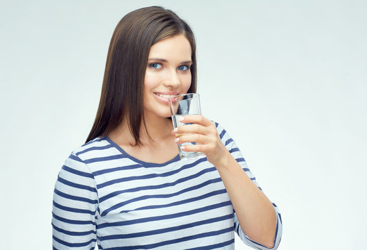 Smiling girl with dental braces drinking water