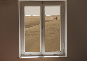 Closed window and a view of a desert on a sunny day