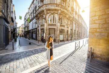 Young woman tourist walking on the street during the morning in Bordeaux city in France