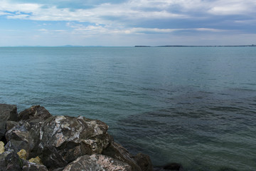 Fototapeta na wymiar Rocks, sea, cloudy sky landscape