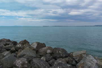 Fototapeta na wymiar Rocks, sea, cloudy sky landscape