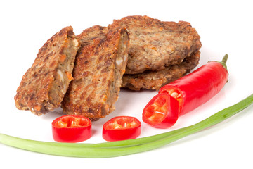 liver pancakes or cutlets with chili pepper and green onions isolated on white background