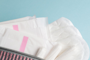 Menstrual tampons and pads in cosmetic bag. Menstruation time. Hygiene and protection