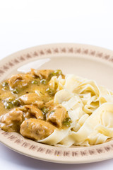 White chicken meat with sauce on the plate in closeup macro.