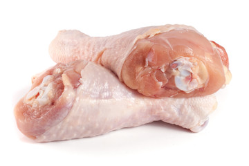 Two raw chicken drumsticks isolated on white background