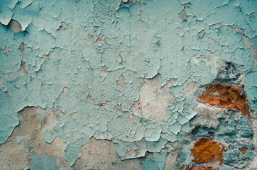 Peeling paint on the old concrete wall