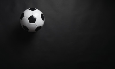 Classic soccer ball on black background.