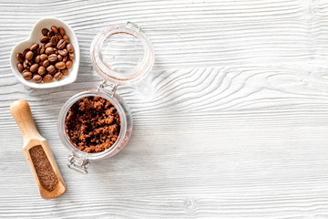 Aroma spa set. Coffee scrub, coffee grains, coffee spa salt on wooden table background top view copyspace