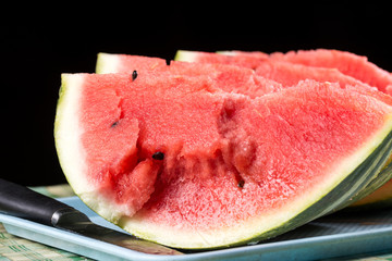 Slices of watermelons on the table with black background.