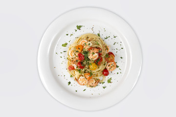 Seafood. Spaghetti pasta with prawns or shrimps with mixed colours cherry tomatoes fresh parsley and pepper.