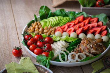 Warm grilled chicken salad with vegetables and fruits