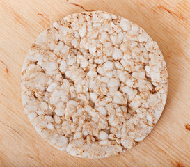 Rice diet bread on an old wooden background, diet food.