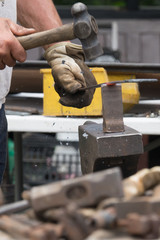 A blacksmith hammering hot iron
