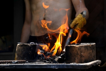Man Preparing a fire with coal for  barbecue