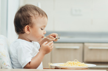 the child greedily eating pasta