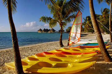 Bora Bora beach scene with colorful kayaks on the beach