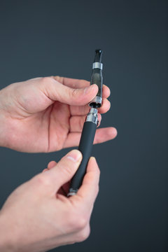 Hands assembling an electronic cigarette