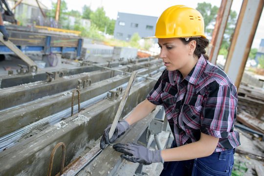 Female builder at work on site