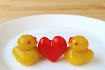 Pair of Baby Duck with Red Heart Marzipans, Thai Traditional Kanom-Look-Choup Sweets Served on White Plate 