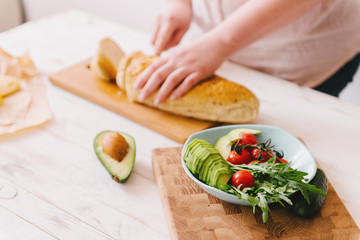 Female hands making sandwiches