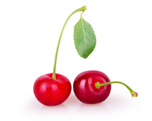 Two ripe cherries on a white background