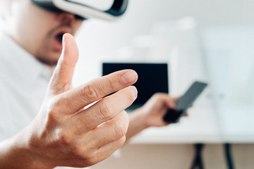 businessman hand working with finances about cost and calculator and laptop with mobile phone on withe desk in modern office