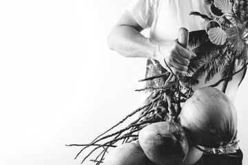 Summer and holiday fashion concept.Man Wearing palm trees graphics on T-shirt and holding cluster of coconuts with items on white background