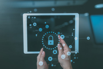 cyber security internet and networking concept.Businessman hand working with VR screen padlock icon on mobile phone and digital tablet computer