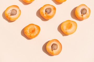 Halves of apricots on a white background. Juicy summer fruit on a table, summer, vitamins