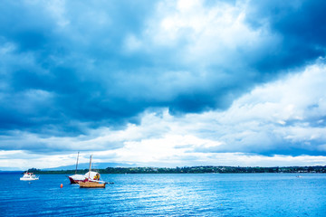 Fototapeta na wymiar Blue lake with boats and coastline