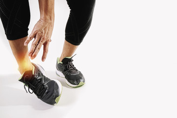 Runner sportsman holding ankle in pain with Broken twisted joint running sport injury and Athletic man touching foot due to sprain on white background - obrazy, fototapety, plakaty