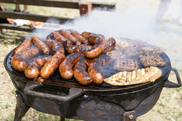 Sausages and white meat roasted on the grill