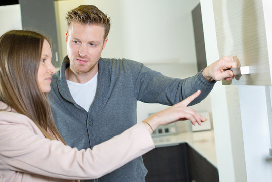 Couple looking at kitchen cupboards